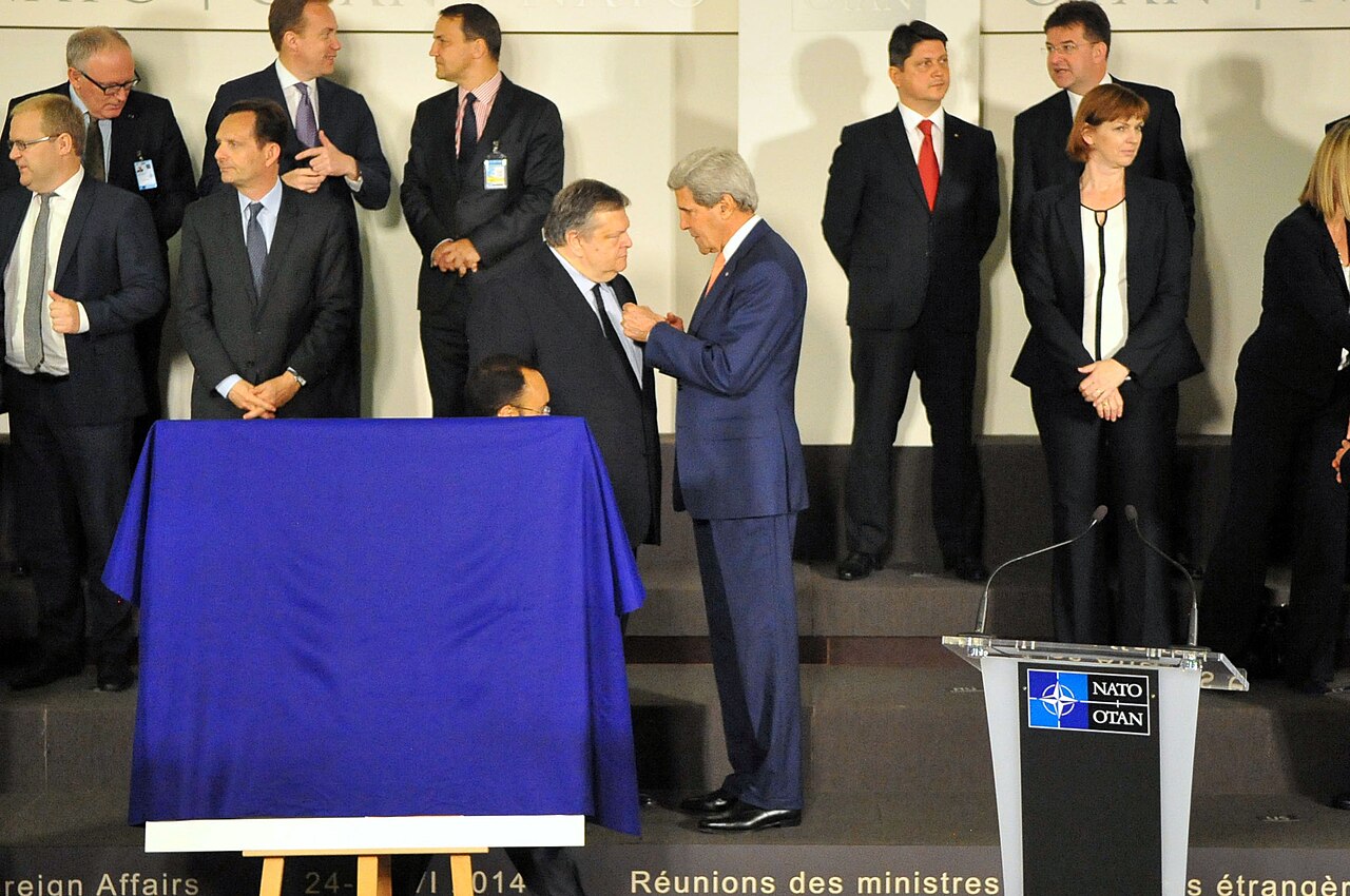 U.S. Secretary of State John Kerry speaks with Greek Foreign Minister Evangelos Venizelos before a group photo amid a series of ministerial meetings at NATO Headquarters in Brussel