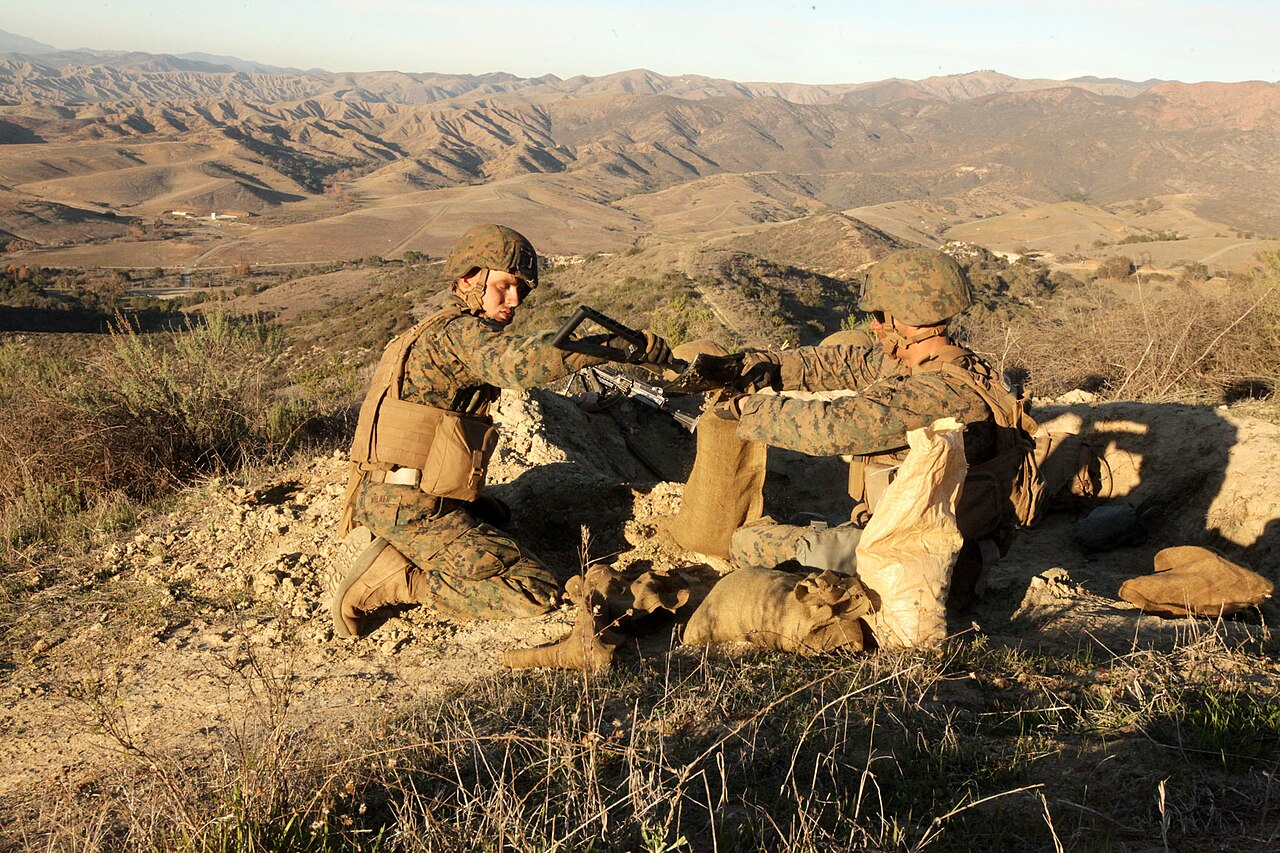 Two Marines with 2nd Battalion, 1st Marines Headquarters platoon fill sandbags at the new defensive position to make barriers during Exercise Steel Knight aboard Camp Pendleton, Ca